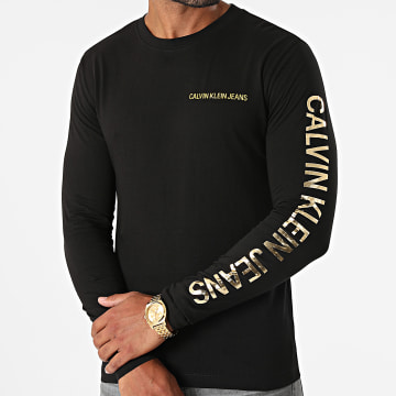  Calvin Klein - Tee Shirt Manches Longues Institutional 0547 Noir Doré