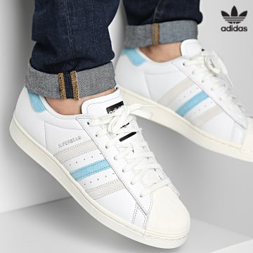 https://laboutiqueofficielle-res.cloudinary.com/image/upload/v1627646526/Desc/Watermark/3adidas_orginal.svg Adidas Originals - Baskets Superstar GY9381 Cloud White Blue Grey One