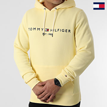 https://laboutiqueofficielle-res.cloudinary.com/image/upload/v1627647047/Desc/Watermark/7logo_tommy_hilfiger.svg Tommy Hilfiger - Sweat Capuche Tommy Logo 1599 Jaune