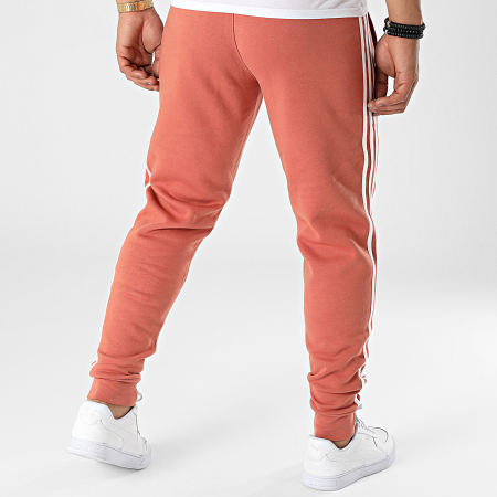 Adidas Originals - HK7300 Pantaloni da jogging a 3 strisce rosso mattone