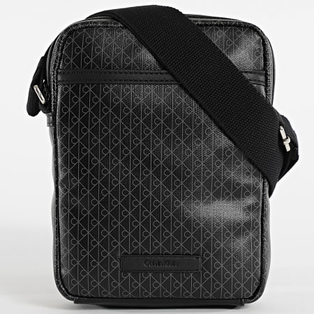 Calvin Klein - Bolsa Emblem AOP Coated Slim Reporter D3334G Negro