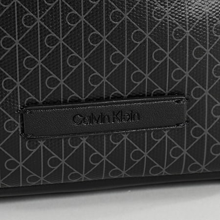 Calvin Klein - Bolsa Emblem AOP Coated Slim Reporter D3334G Negro