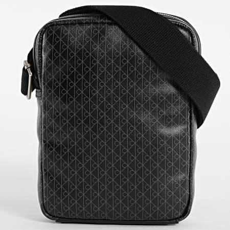 Calvin Klein - Bolsa Emblem AOP Coated Slim Reporter D3334G Negro